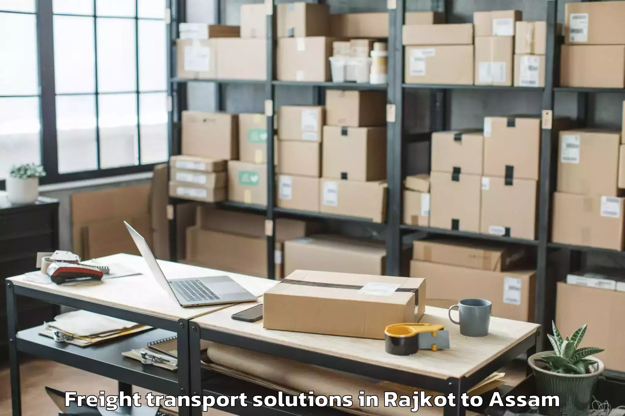 Easy Rajkot to Khoirabari Pt Freight Transport Solutions Booking